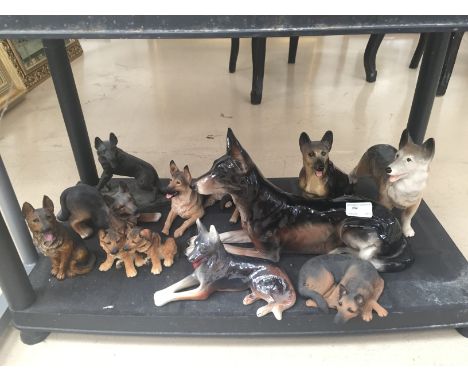 A shelf of german shepherd figures