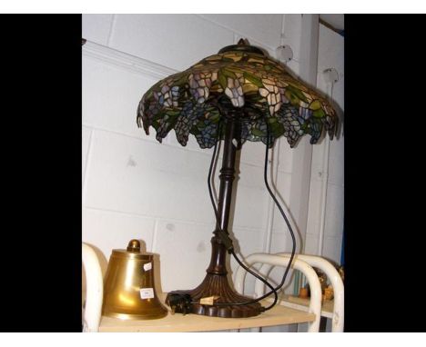 A Tiffany style table lamp together with a commemorative bell