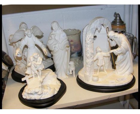 A collection of Lenox bisque religious figures, together with various tankards