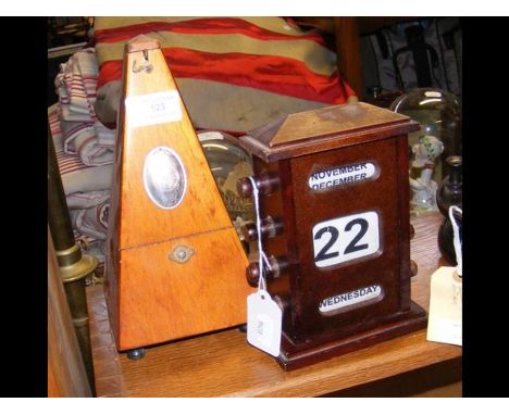 A perpetual desk calendar, together with a metronome 