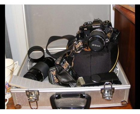 A Nikon FG camera with telephoto lens and accessories