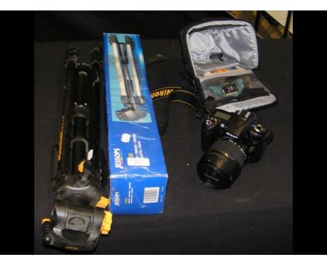 A Nikon D90 Camera - cased, Tamron AF lens - cased, together with two tripods CONDITION REPORTGood conditionno battery charge