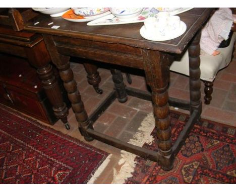 An oak side table on bobbin support