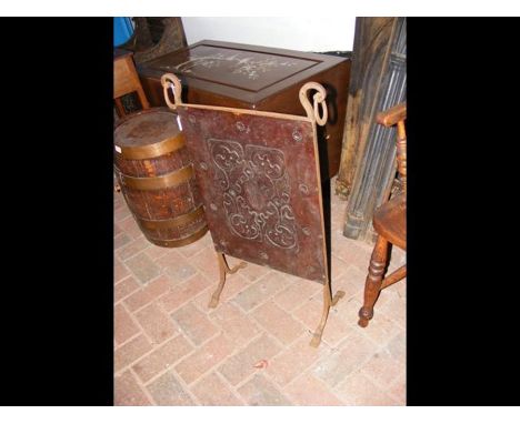 An Arts &amp; Crafts style fireguard with embossed panel 