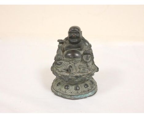 19th century Chinese Budai, or laughing Buddha, bronze figure seated upon a lotus flower grasping a string of beads and fan. 