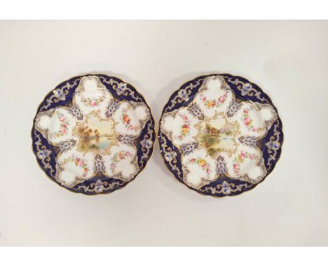 Pair of Royal Worcester cabinet plates decorated with river scenes within blue and gilt borders. Diameter 22cm