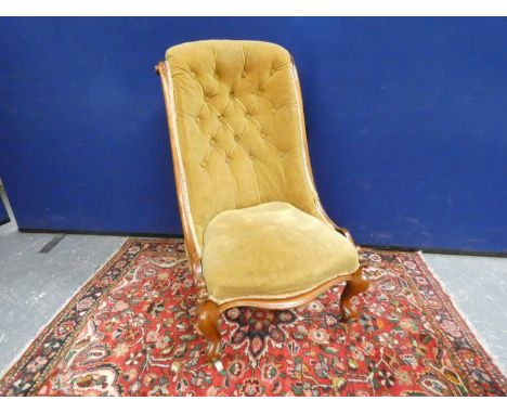 Victorian button back nursing chair in lime velvet upholstery, raised on cabriole supports. Height 94cm.