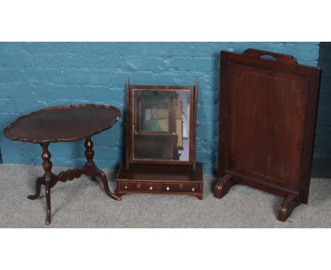 A mahogany fire screen along with a mahogany occasional table and a toilet mirror.  