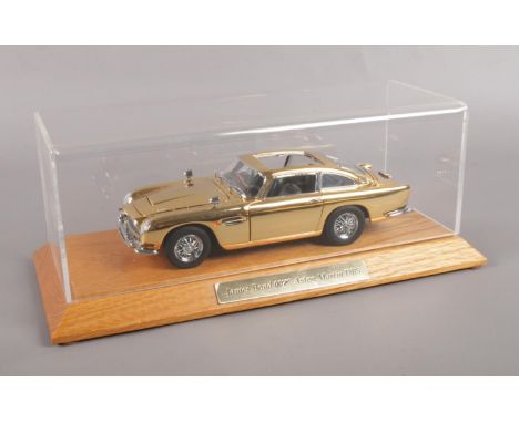 A Danbury Mint Special edition James Bond Aston Martin DB5, Gold Plated, built to 1:24th Scale. Display case, &amp; certifica