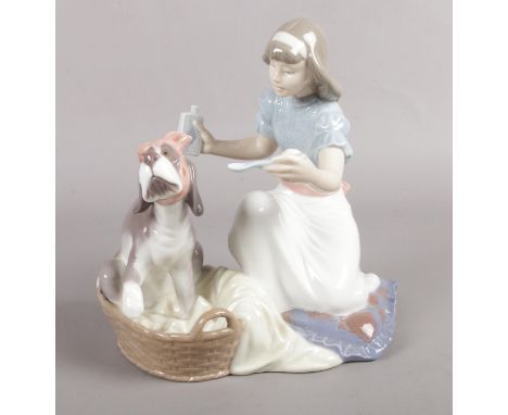 A Lladro figure 5921 'Take your medicine'.  