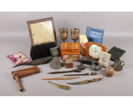 A box of collectable items. To include a series of letter openers, carved wooden alligator, a pair of EPNS goblets and the Au