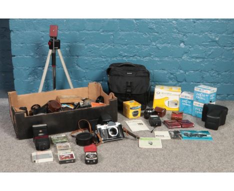 A box of photographic equipment and accessories. To include three boxed Minolta lenses, Hoya filters, Leica leather camera co