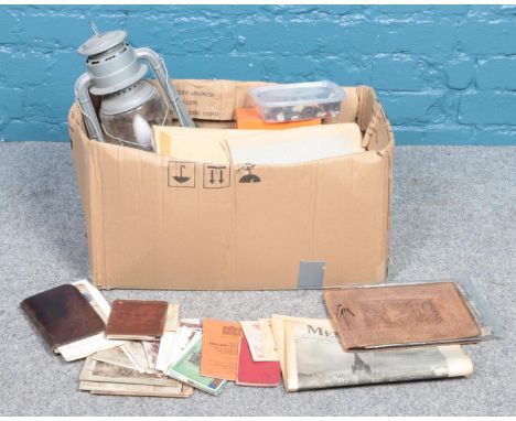 A box of miscellaneous item. To include a collection of postcards and photographs, an electrical converted Fleurhand lamp and