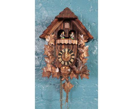 A German carved cuckoo wall clock. with Regula, West Germany movement and Swiss Musical movement, playing Edelweiss, pendulum
