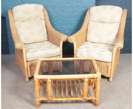 A four piece rattan conservatory suite. Comprising of two seat sofa, two armchairs and glass top coffee table.  