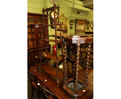 A 1920's oak umbrella stand, together with an inlaid mahogany plant stand and a four tier hanging shelf