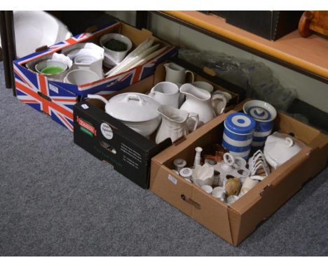 A quantity of white and cream glazed ceramics including jugs, egg cruets, serving plates, etc 