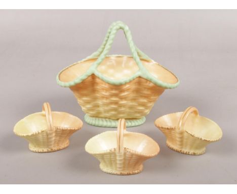 Four late 19th/early 20th Royal Worcester blush ivory baskets, including three miniature examples.  