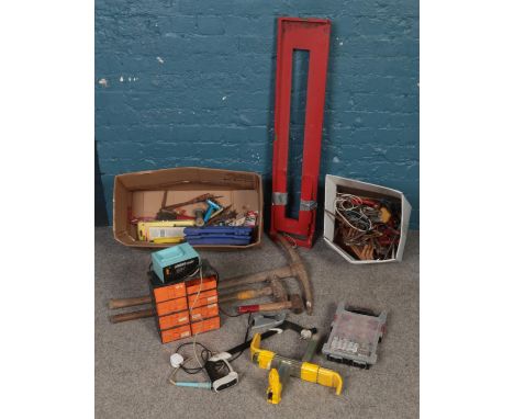 A quantity of of tools. Including sledge hammer, pickaxe, hammers, car clamp, etc.  