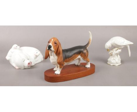 A collection of ceramic figure's. Beswick Bassett hound, Beswick Little Likeables 'Hide &amp; Sleep' pigs, Dresden bird No 10