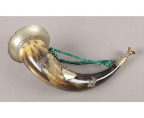 A large horn hunting bugle, with white metal central plaque, decorated with deer. 34cm long.  Crack to mouthpiece.