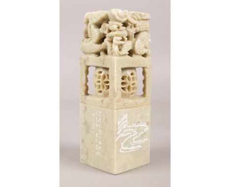 A Chinese carved soapstone name seal. With Chinese characters and drawing to each side and bottom and dragon top. H: 12cm,W: 