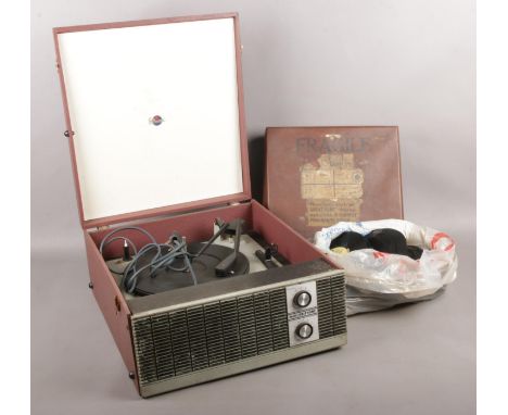 A Marconiphone record player with a selection of 78's and loose 45's. Artists to include Pyramids, The Bachelors and Desmond 