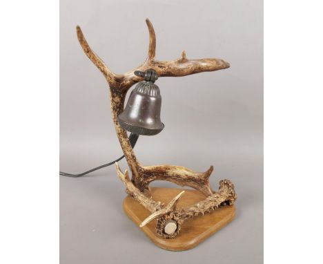 A novelty antler table lamp on wooden base.  
