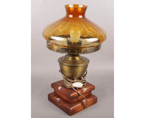 A coloured glass and brass oil lamp converted to electric.  