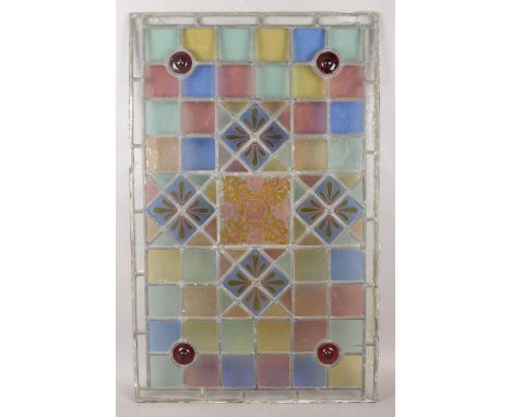 A large Victorian lead glazed stained glass panel, with decorative central pane surrounded by diamond and bullseyes to the co