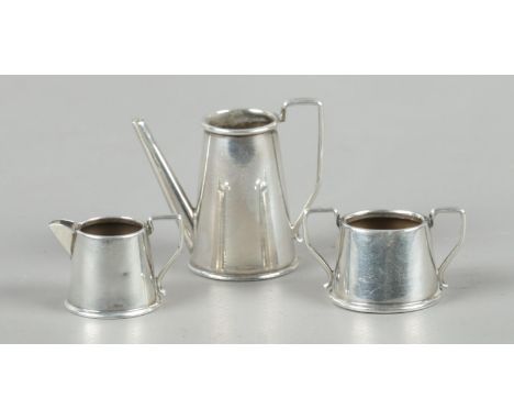 A three piece miniature silver tea service, all assayed for Birmingham, 1962, by John Rose. Total weight: 23.61g.  