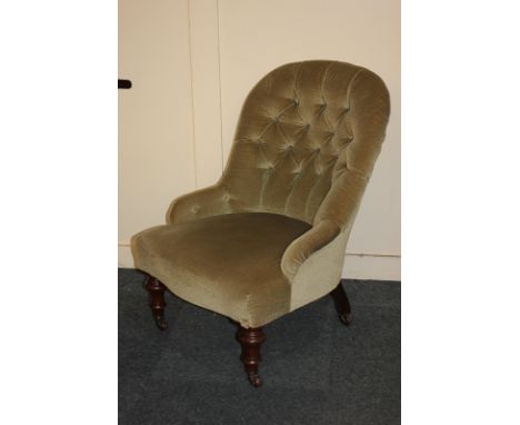A Victorian button back upholstered nursing chair on turned legs and castors