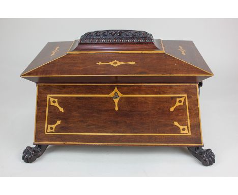 A large 19th century sarcophagus tea caddy, the carved and inlaid cover enclosing two wooden canisters and a later glass, wit