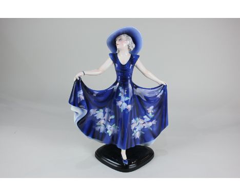 A Josef Lorenzl for Goldscheider Art Deco figure of a lady in blue hat and sun dress, 37cm, (a/f)