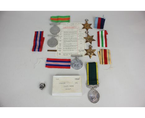 An Efficient Service medal with Territorial bar awarded to T.2035386 PTE A P Crouch RASC, in original box, a TA badge, and a 