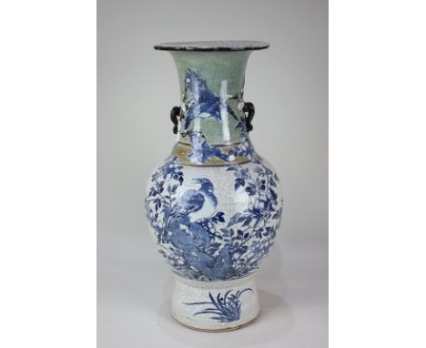 A Chinese crackle ware vase, baluster form, decorated in blue with birds and butterflies amongst a flowering bush, on white, 