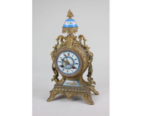 A French gilt metal and enamel mantel clock with 8cm blue and white enamel dial, plaque and vase surmount, decorated with vie