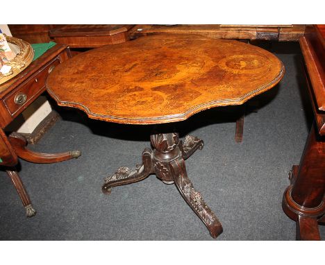 A 19th century burr wood tilt-top table, the shaped oval top decorated with panels depicting a hunting party, deer and stags,