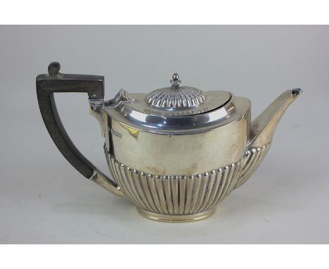 A George V silver bachelor's teapot, oval form with demi fluting, maker Mappin &amp; Webb, Sheffield 1913, (a/f) 9oz gross we