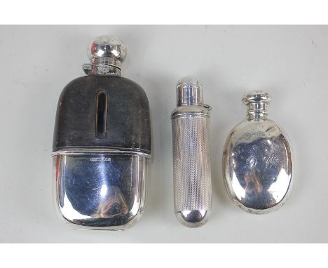 A Victorian silver and glass hip flask with twist top, brown leather mount and silver beaker, Sheffield 1886, 14cm, a smaller