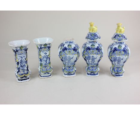 A set of faience pottery vases and urns, comprising two bud vases depicting women, two urns with covers depicting a man playi