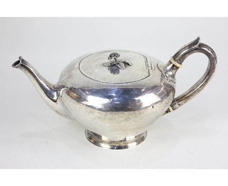 A Victorian silver teapot, plain circular form with rosebud finial and scroll handle, maker probably Benjamin Smith, London 1