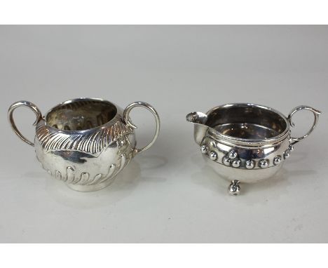 A George V silver cream jug, maker J Gillmore, Birmingham 1917, together with a silver sugar bowl, maker Edward Hutton, Londo