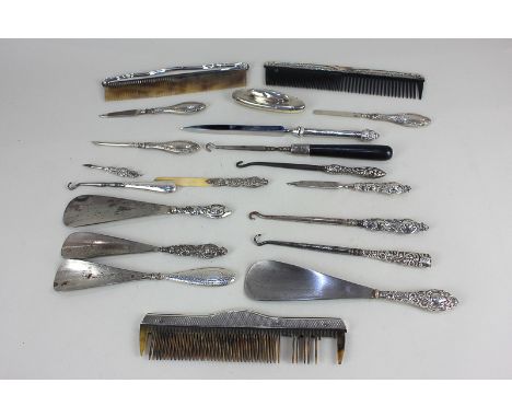 Three silver mounted combs, four silver handled shoe horns, together with various silver handled or mounted button hooks and 
