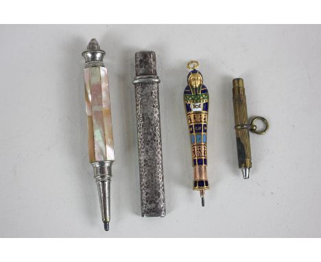 A silver gilt and enamel 'Egyptian mummy' slide pencil, a silver pencil case, two pencils