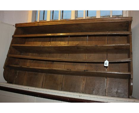 A 19th century rustic wall shelf with oak plank back 122cm wide