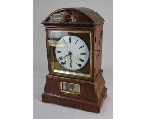 A 19th century cuckoo mantel clock with 14cm white enamel dial, and Roman numerals, in domed case with panel to base showing 