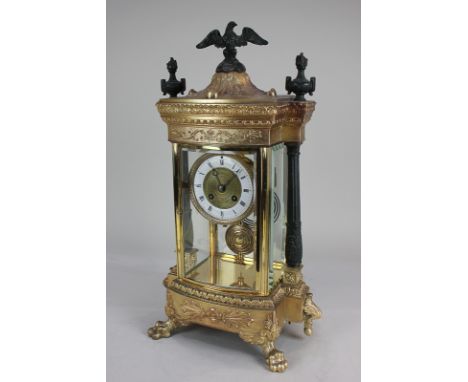 An Empire style gilt metal mantel clock with 10cm gilt and white enamel dial with Roman numerals, in four-sided rectangular g