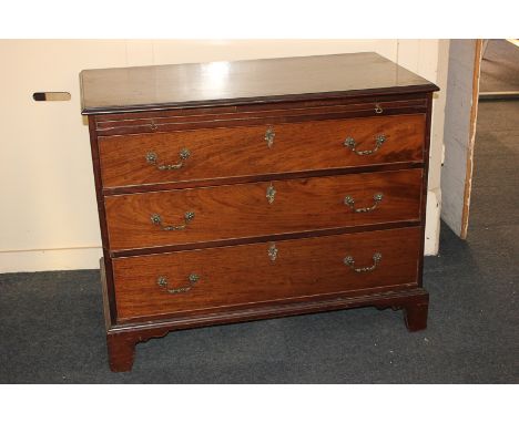 A George III mahogany chest of three drawers, with pull-out slide, on bracket feet, 102cm
