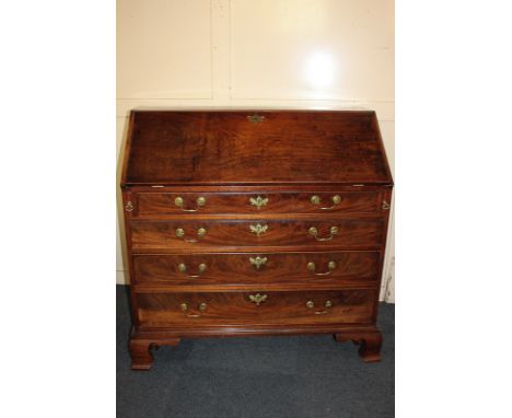 A George III mahogany bureau, the fall enclosing various drawers and pigeon holes, above four long drawers on bracket feet 10